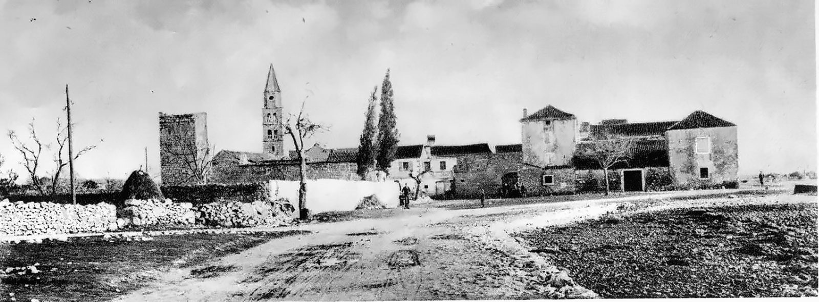 Turanj around 1930 — the tower of the Croatian Meštrović nobles, the church belfry and dry-stone walls along the dirt road